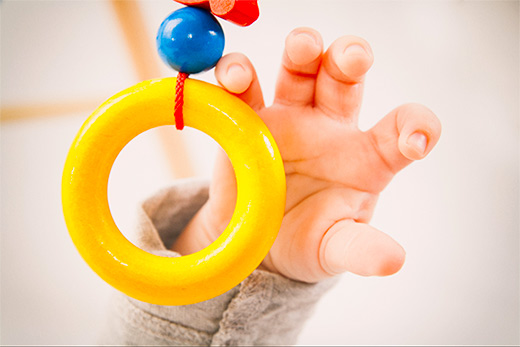 Image of baby's hand with a toy